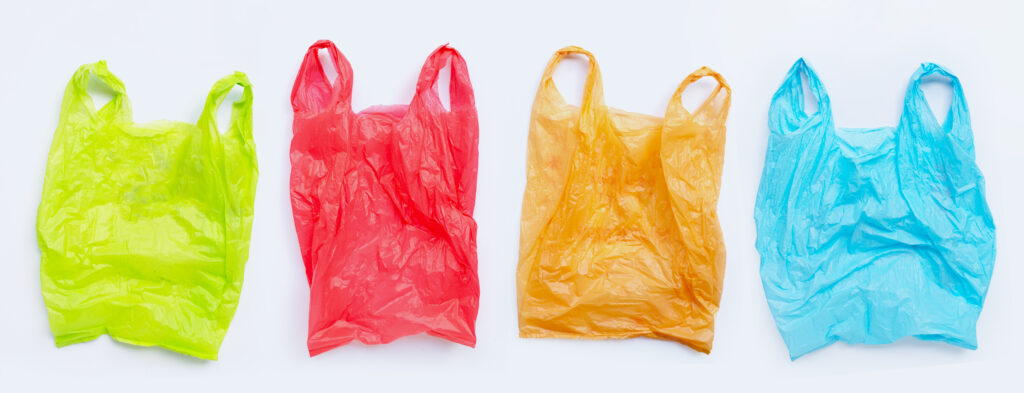 Colorful plastic bags on white background.