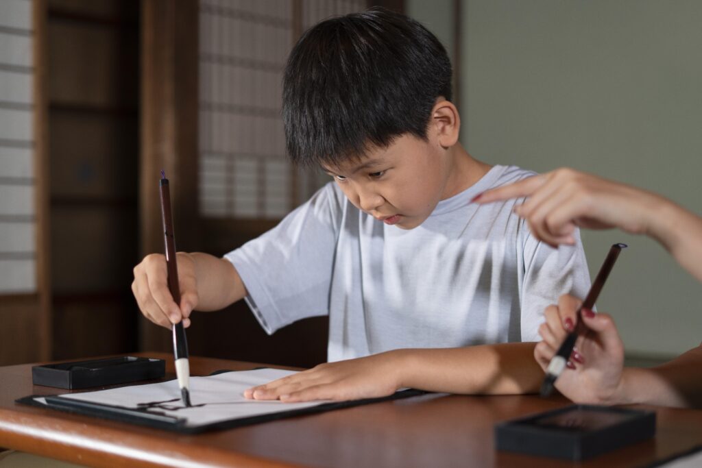 Close up person doing japanese calligraphy called shodo