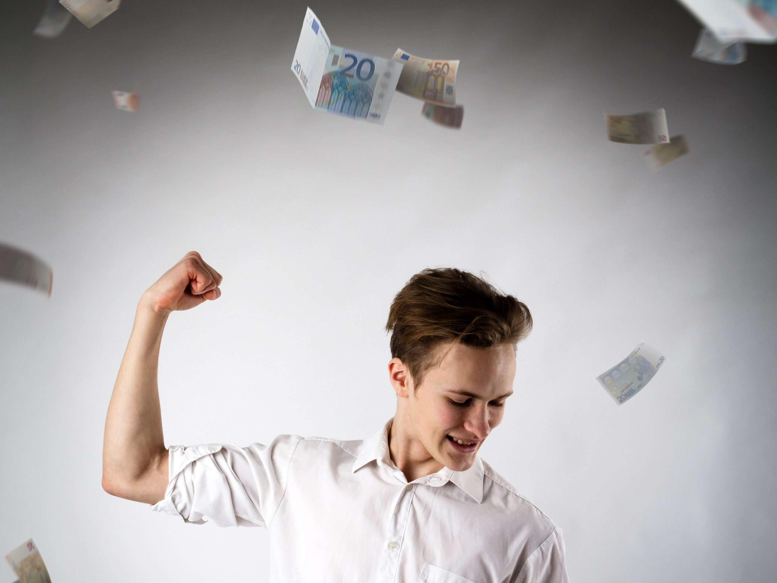 Young man in white is rejoicing. man in white and euro.